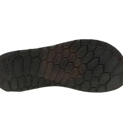 chaco low down flip sandals beside a backpack, ready for travel or day hikes


