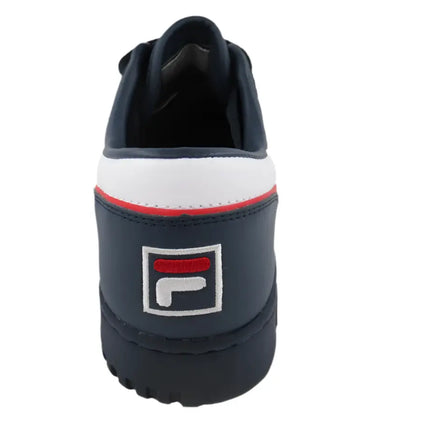fila original fitness shoes resting on concrete ledge during urban shoot