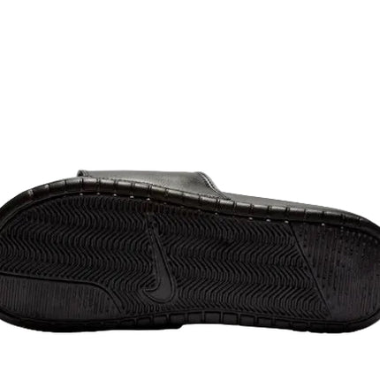 The image displays the underside of the NIKE BENASSI JDI SLIDE by NIKE, featuring a black textured sole and central swoosh logo. The lightweight slide is photographed on a plain white background.