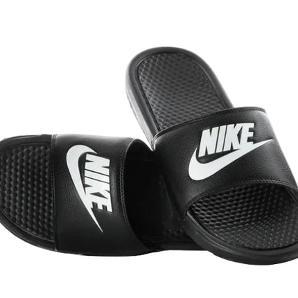 A pair of NIKE BENASSI JDI SLIDE sandals in black, featuring textured footbeds and white NIKE logos on the straps, displayed on a white background—ideal lightweight slides for sporty comfort.