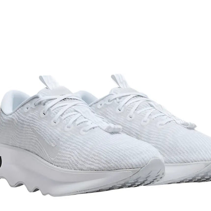 Nike Motiva men’s walking shoes on a city sidewalk

