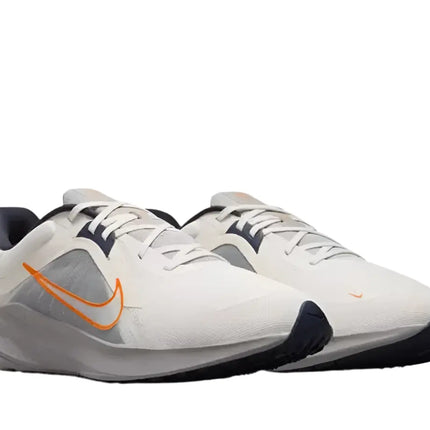 Man wearing Nike Quest 5 Men’s running shoes on track

